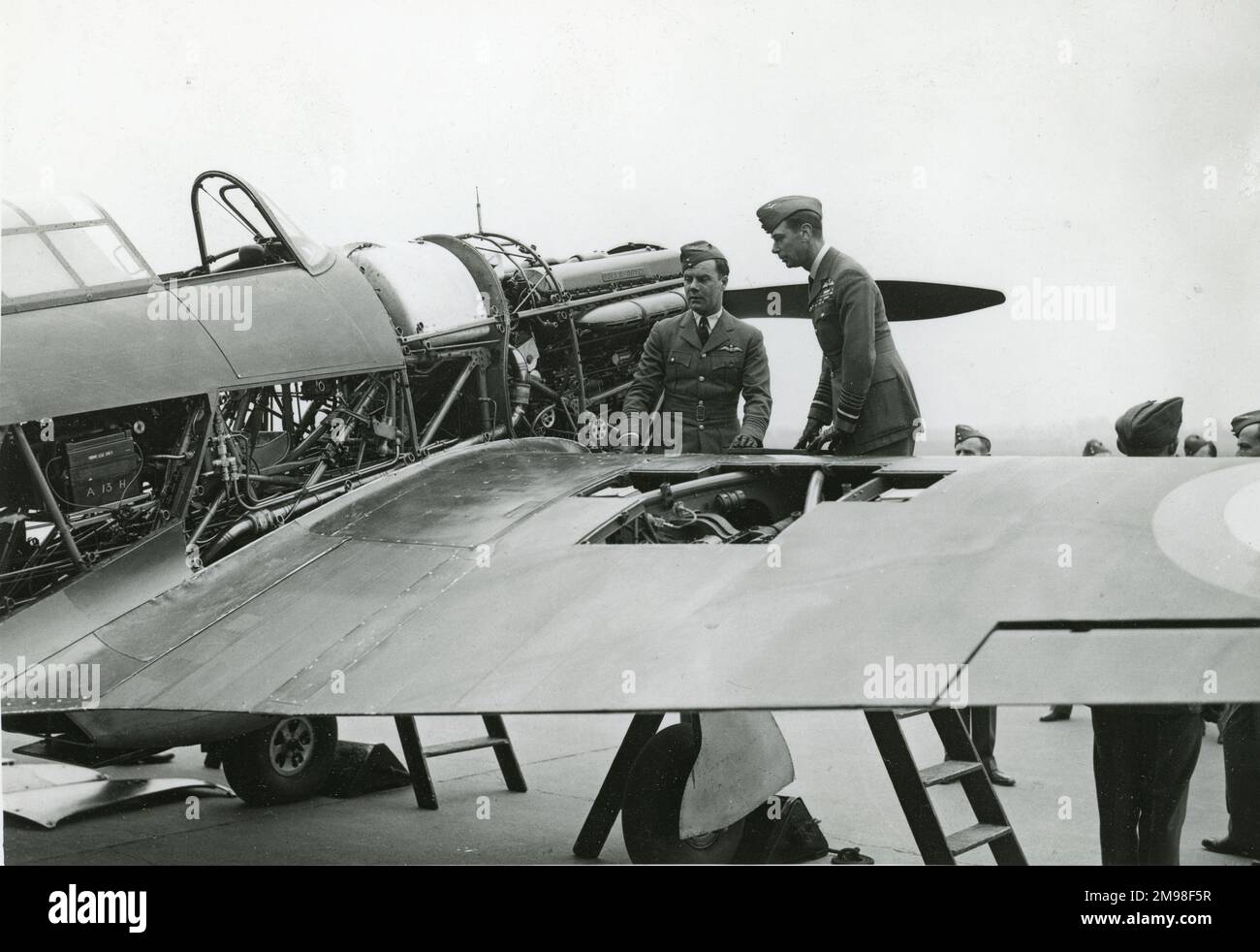 HM King George VI congratulating Sqn Ldr John Woodburn Gillan and inspecting the Hawker Hurricane on which he made a record flight from London to Edinburgh on 11 February 1938. The photograph was presented to the Society by Mrs Gillan, the mother of the pilot, in August 1944. Stock Photo