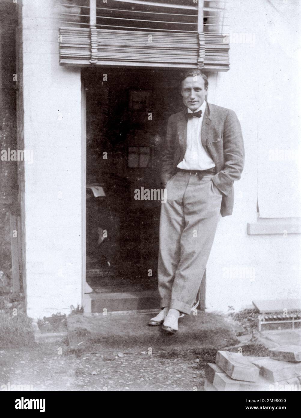 Reg Carter (1886-1949), freelance commercial artist, outside his studio at Granville House, High Street, Southwold, Suffolk. He gave painting lessons to the young Harold Auerbach when the latter was in Southwold on holiday. Stock Photo