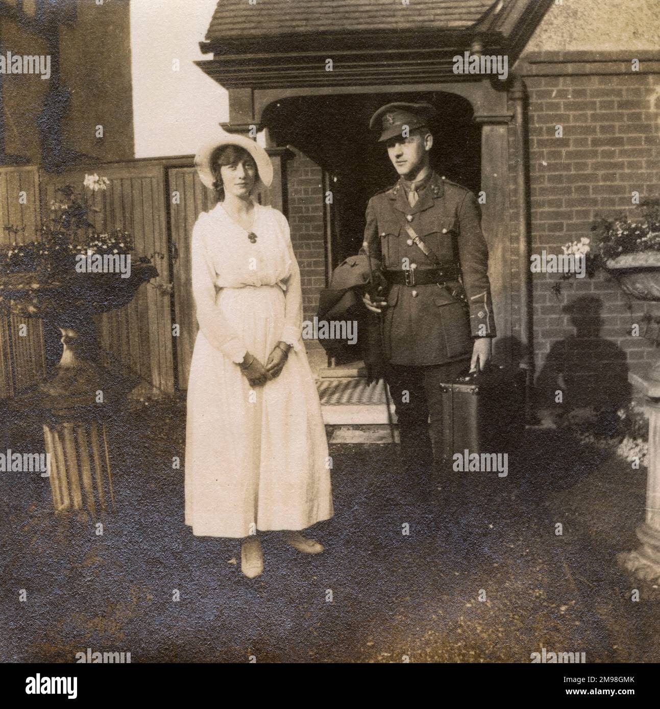 Soldier on leave, about to return to duty, standing with his fiancee in front of her home in Cheam, Surrey, during the First World War. They are Albert Auerbach and Molly Bowie. She is wearing his Royal Fusiliers badge on her blouse. Stock Photo