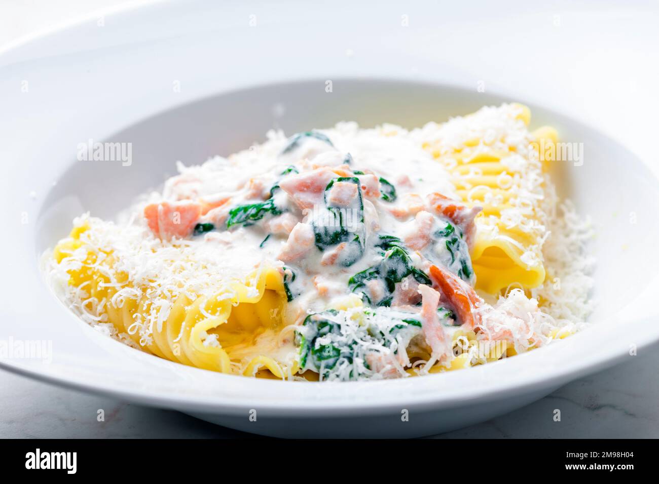 pasta with creamy salmon sauce with spinach Stock Photo - Alamy