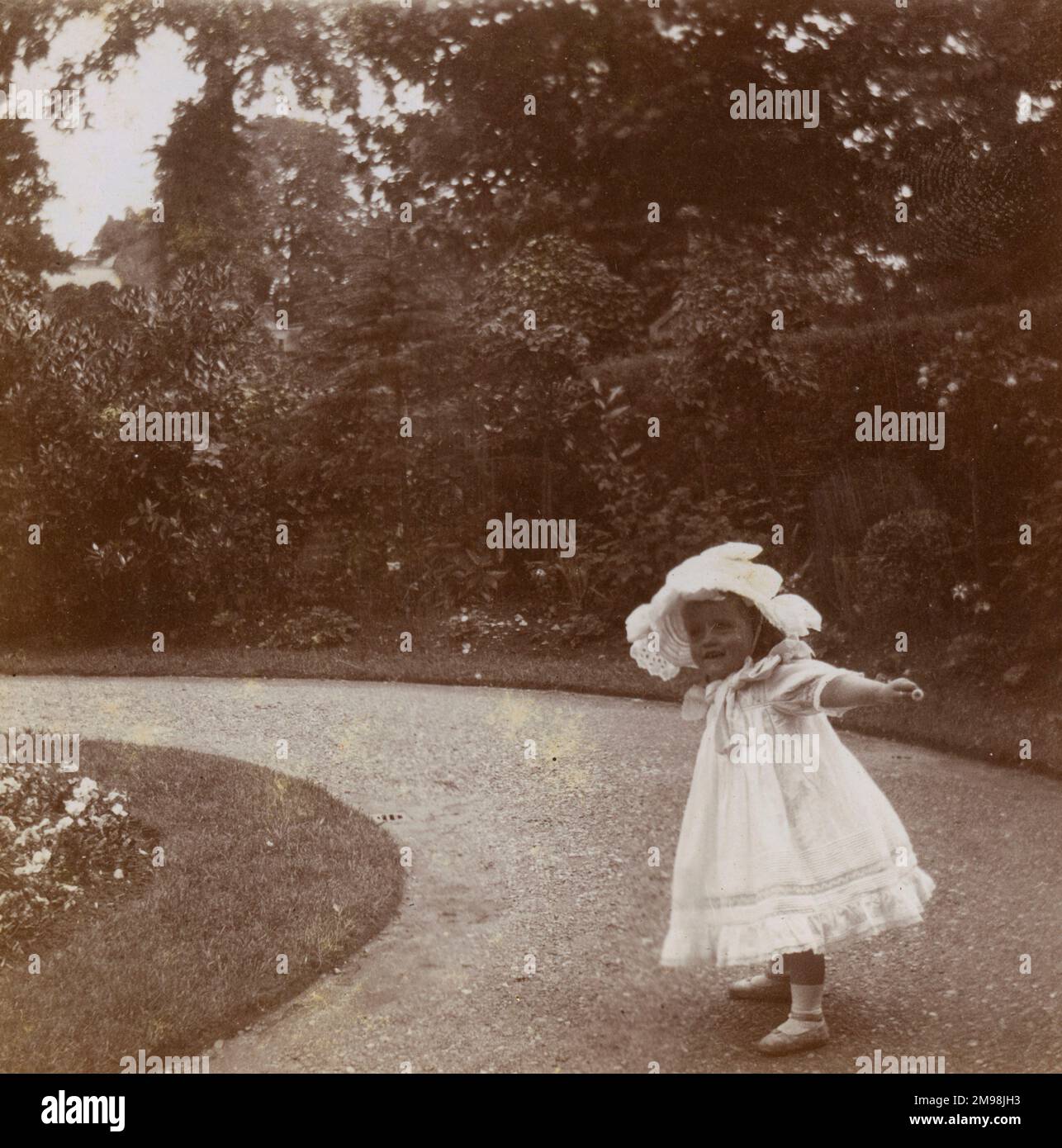 Little girl (Violet Auerbach) in the front garden of her home at 1