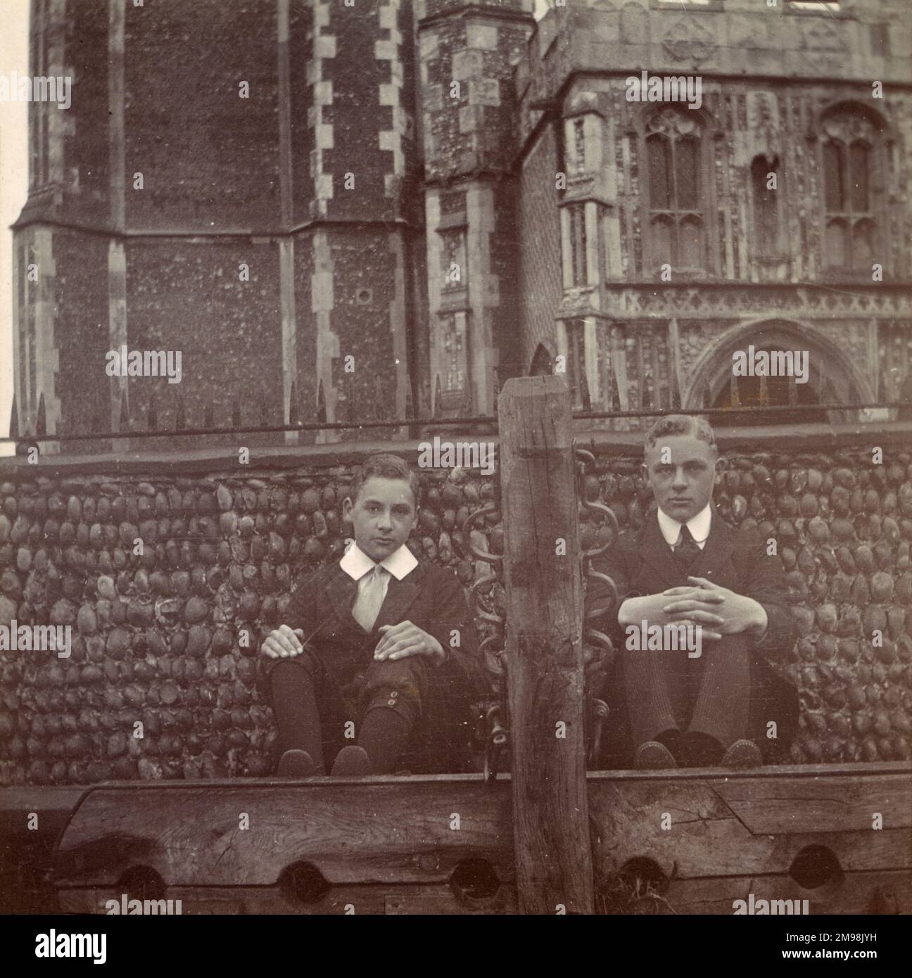 Two boys sitting behind the stocks in Southwold, Suffolk, September 1910. They are Harold and Albert Auerbach. Stock Photo
