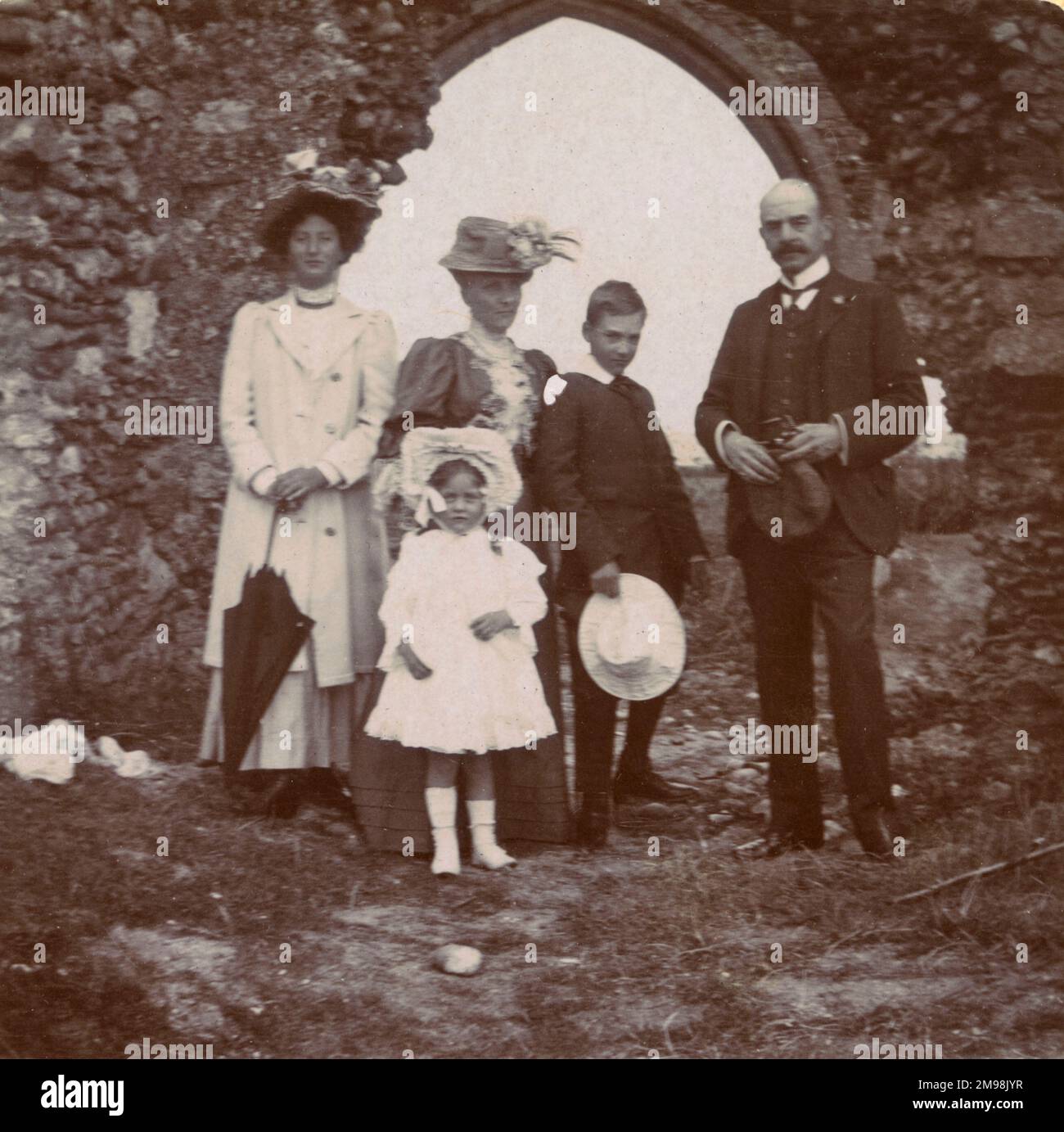 Family (Arthur, Harold, Lucy, Ellen and Violet Auerbach) on a holiday outing to the village of Dunwich, Suffolk, August 1908. The building behind them is All Saints' Church, abandoned in the 1750s. By this time coastal erosion meant that the building was on the cliff edge: the tower fell in 1922. Stock Photo