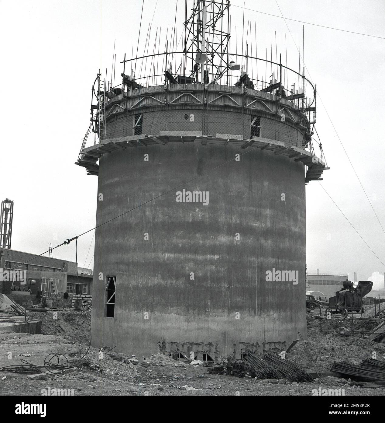 1950s, historical, a circular concrete tower reinforced with steel rods ...