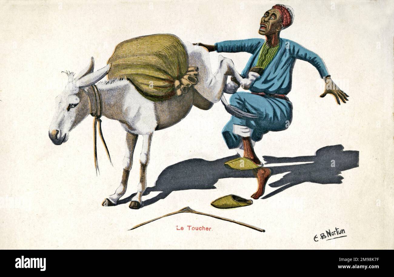An Egyptian man is kicked by his mule, probably in retaliation for giving it too much to carry. Stock Photo
