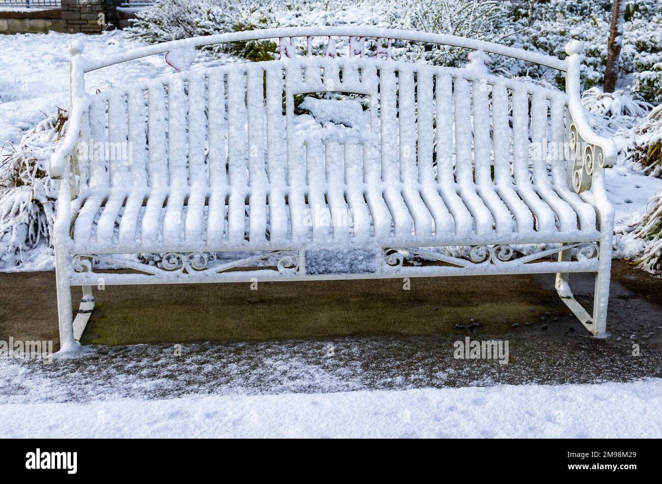 Park Bench covered in Winter Snow Stock Photo
