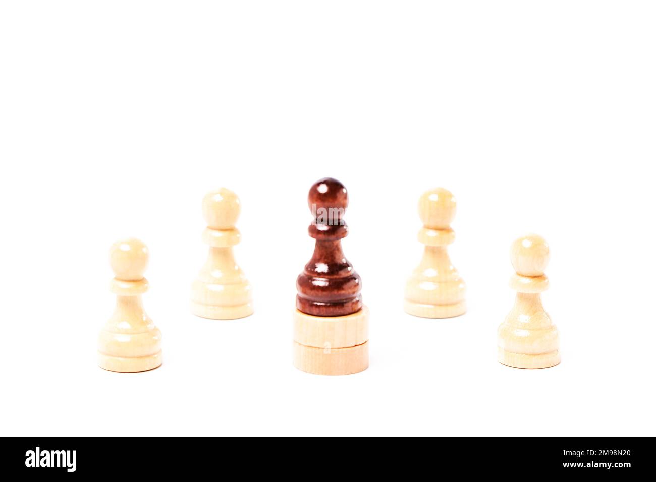White chess pawns surrounding a black pawn on white background. Business concept Stock Photo