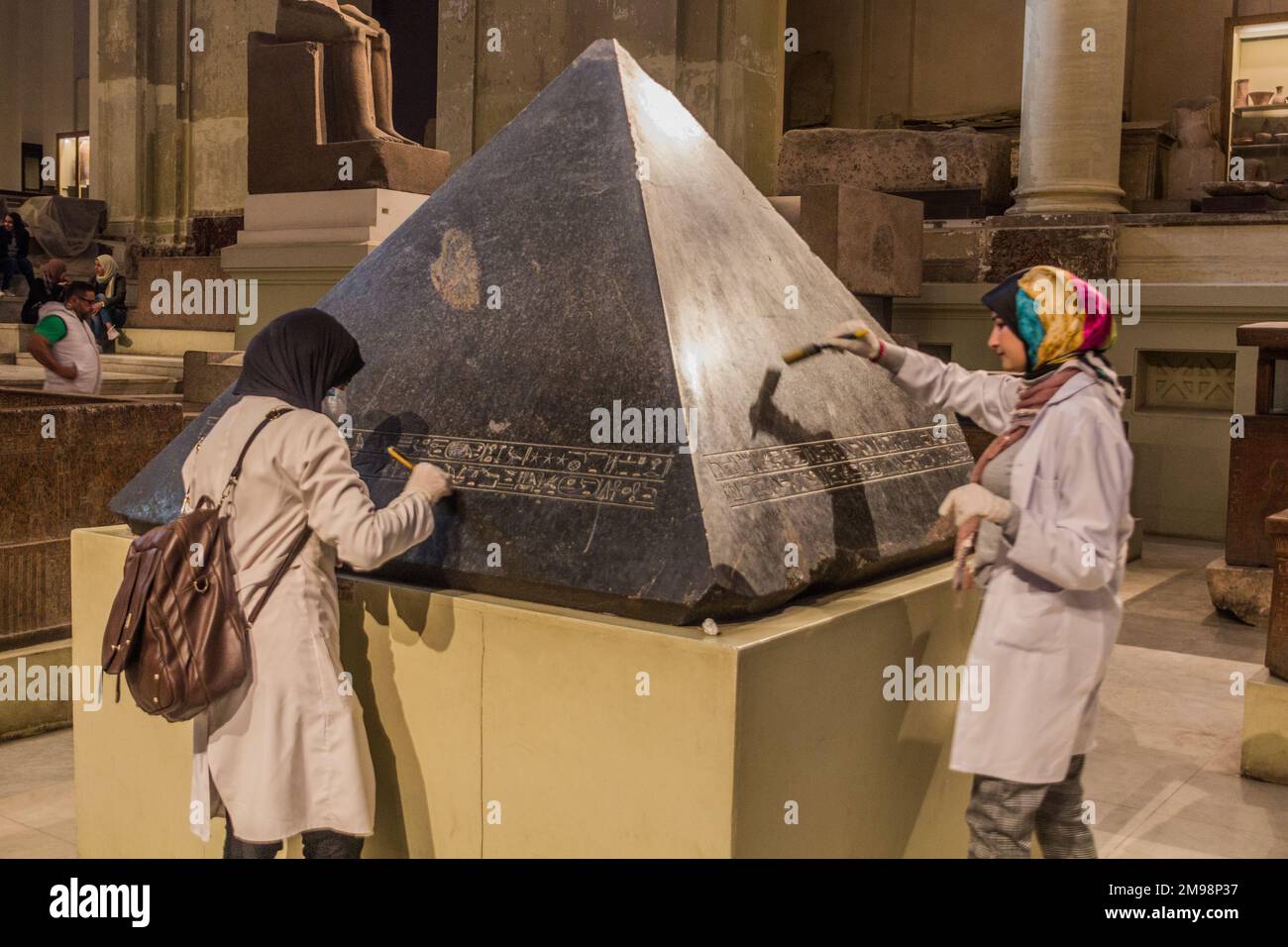CAIRO, EGYPT - JANUARY 27, 2019: Employees cleaning a pyramidion in the ...