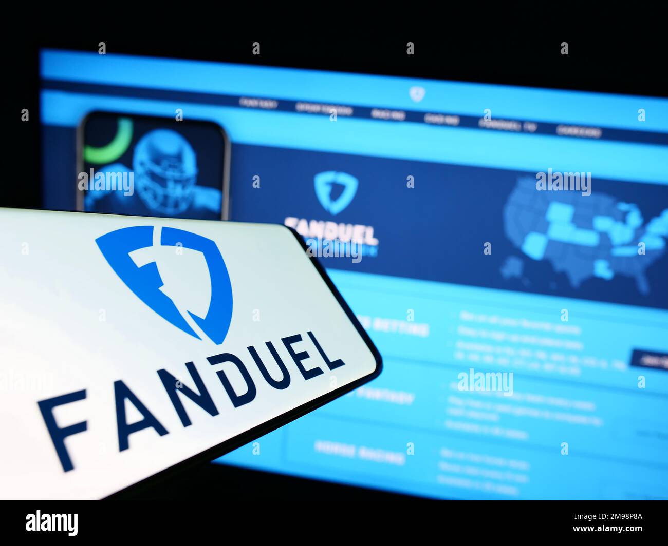 Smartphone with logo of American gambling company FanDuel Inc. on screen in front of business website. Focus on center-right of phone display. Stock Photo