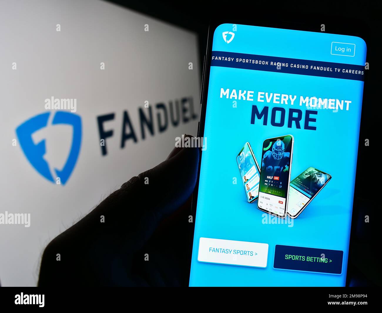 Person holding cellphone with webpage of US gambling company FanDuel Inc. on screen in front of business logo. Focus on center of phone display. Stock Photo