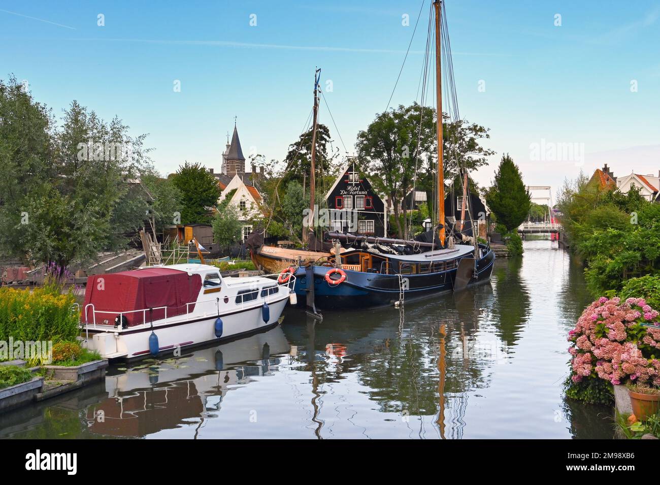 Zaandam, Netherlands - August 2022: Boats moored on one of the canals in the Dutch town of Edam, which is famous for its cheese. Stock Photo