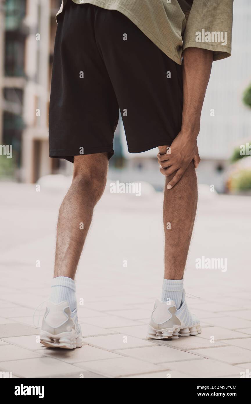 Professional male athlete suffering from hamstring strain Stock Photo