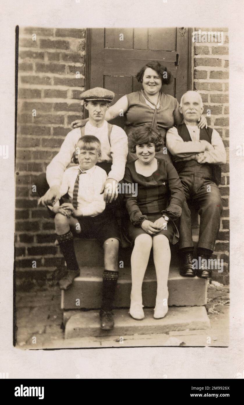 The Winter Family on a Summer's Day! Posing for a family group portrait on the back step of their home. Three generations pictured. Stock Photo