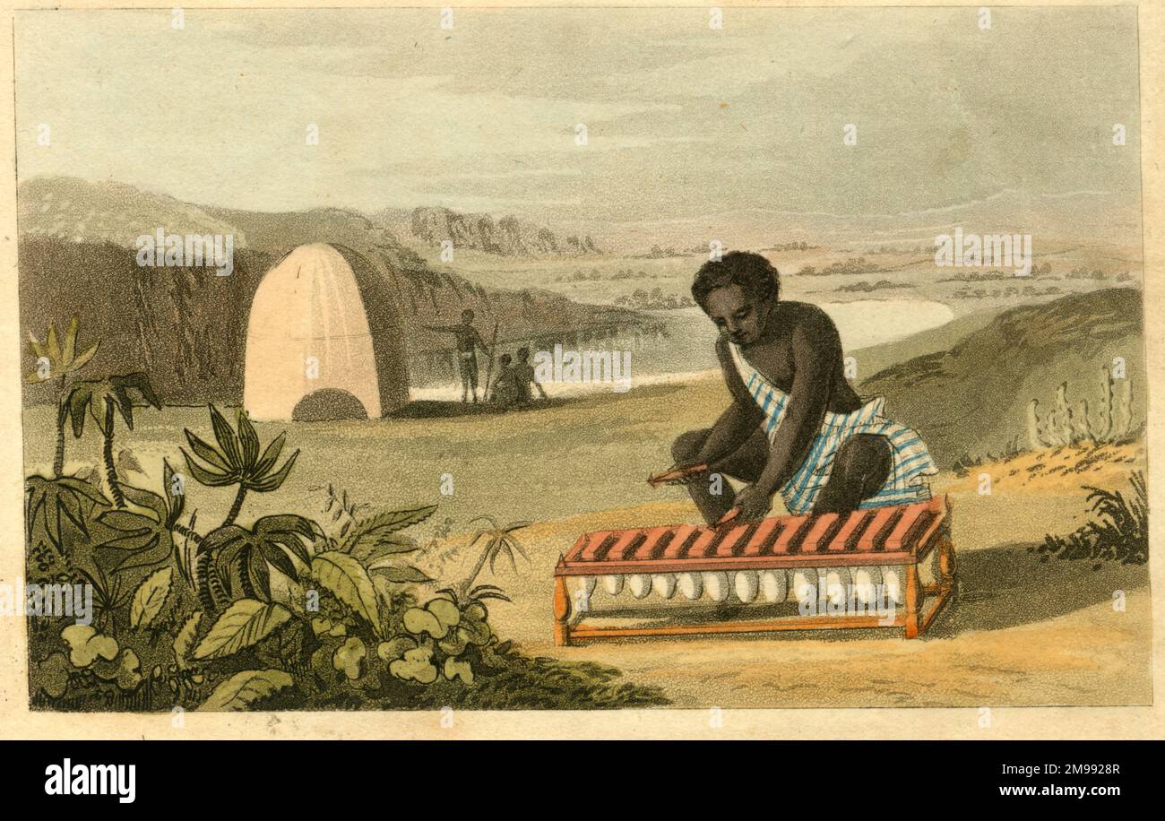West African native playing a musical instrument known as a