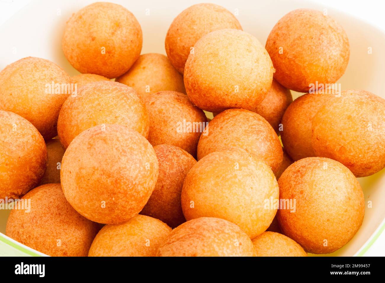 Traditional Colombian Buñuelo Deep Fried Cheese Bread On White