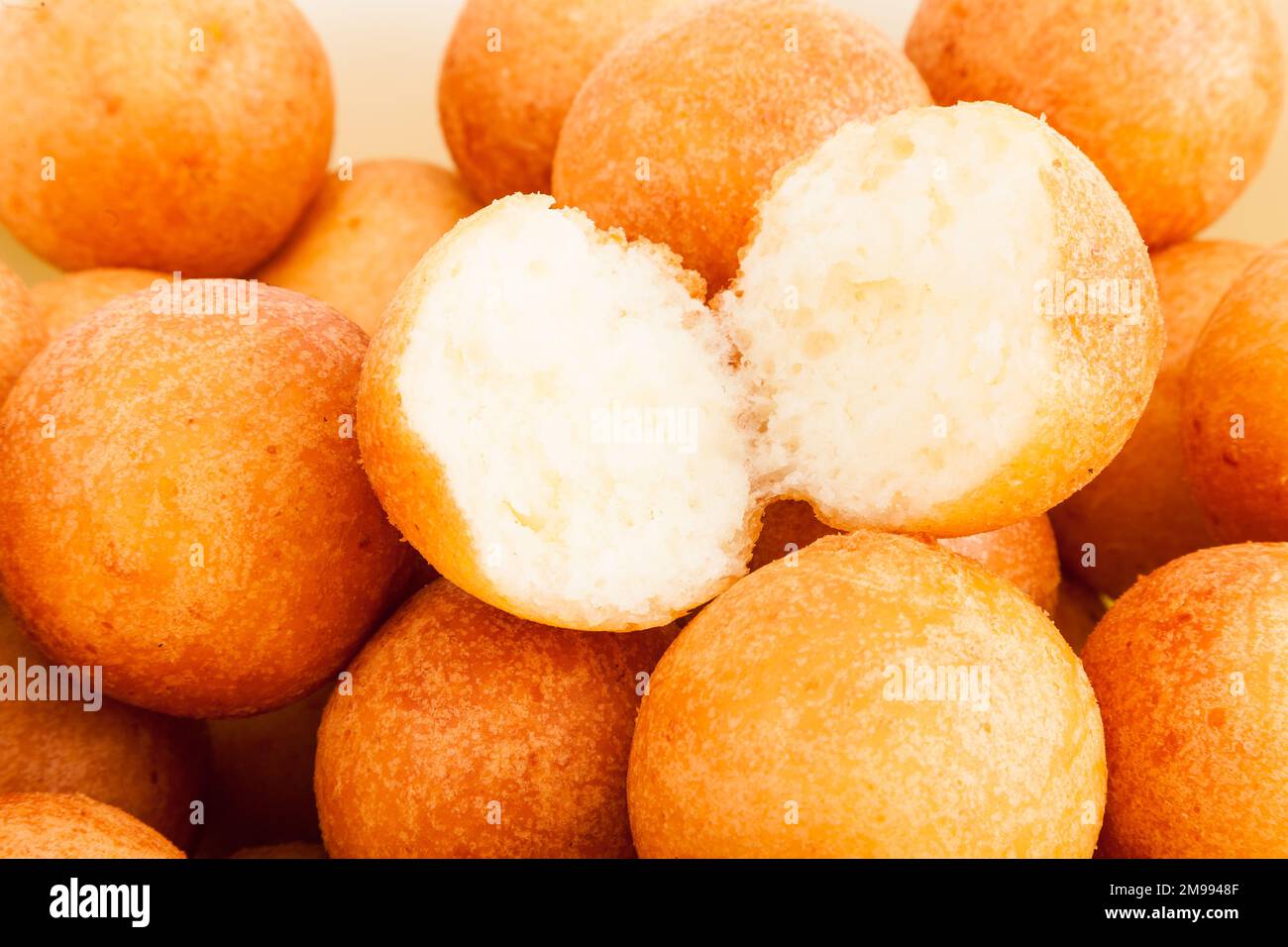 Traditional Colombian Buñuelo Deep Fried Cheese Bread On White