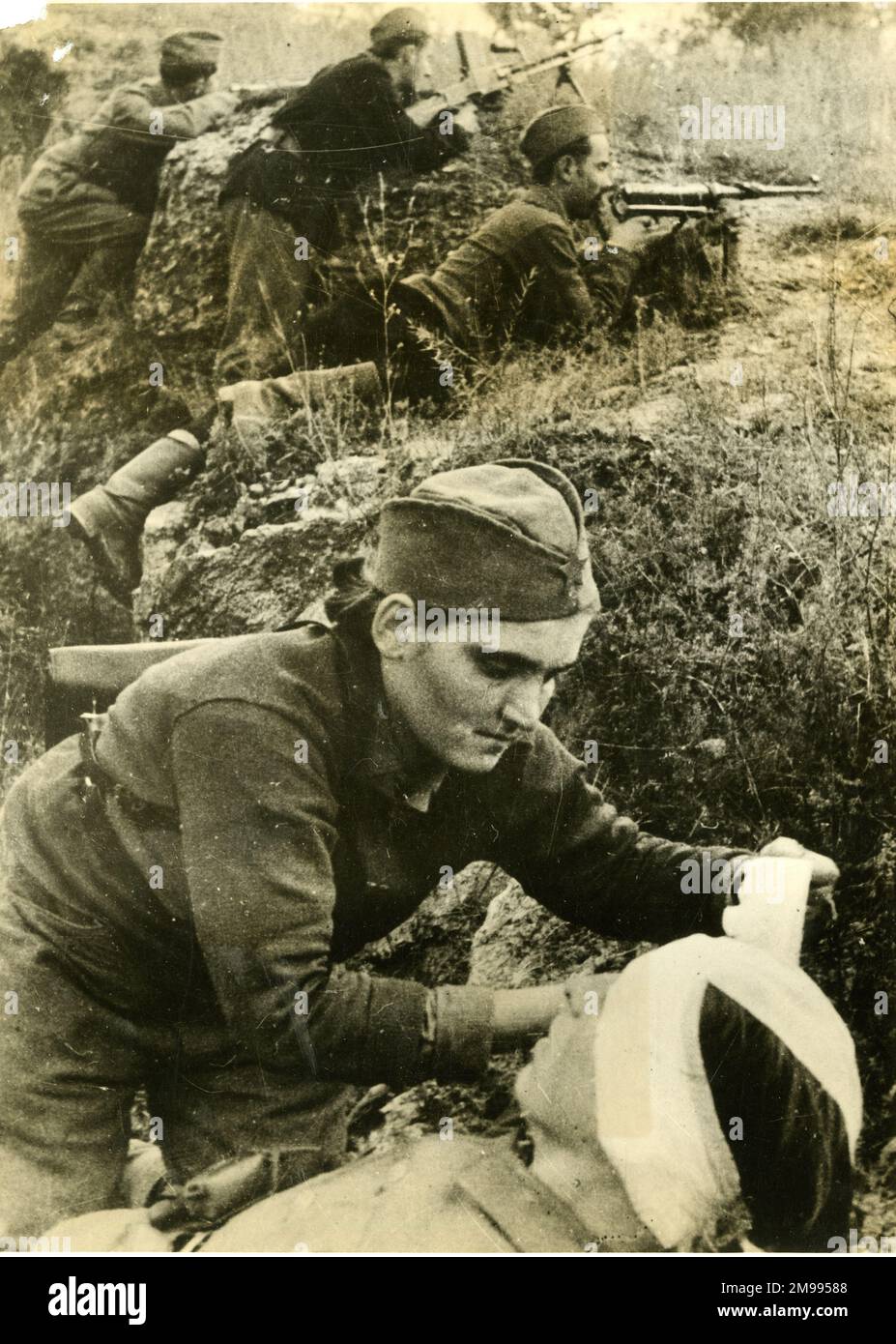 Bandaging a wounded man, Russian Sector of Yugoslavia (Balkans), during the Second World War. Stock Photo