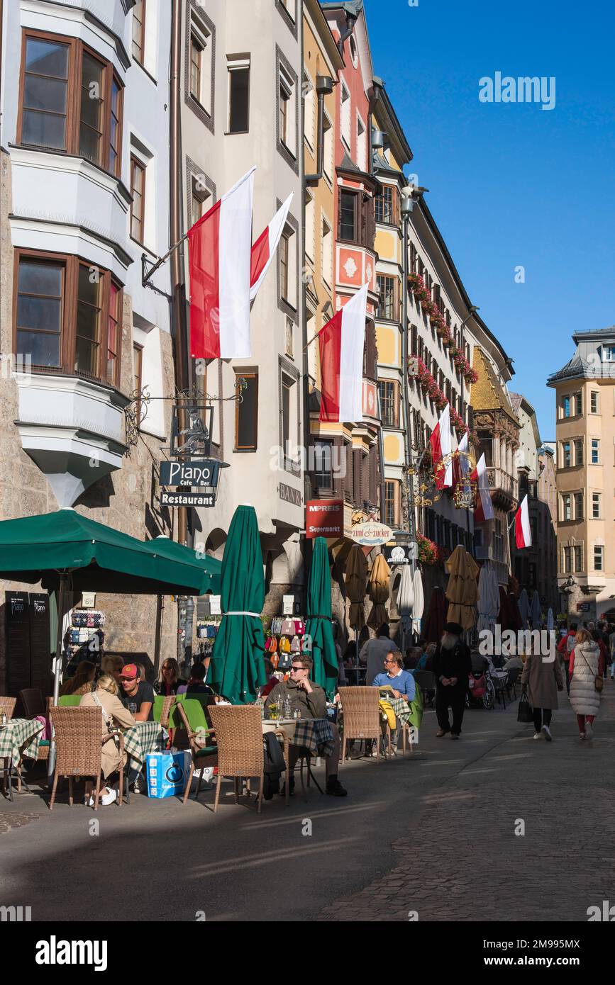 Innsbruck Austria, view in summer of people relaxing at cafe tables in Herzog Friedrich Strasse in the historic old town quarter of Innsbruck, Austria Stock Photo