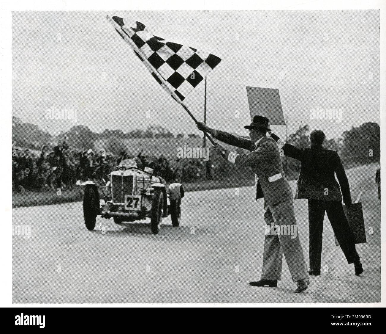 Charley Dodson crossing the finishing line in an MG Magnette, winning the 1934 Tourist Trophy Race. Stock Photo