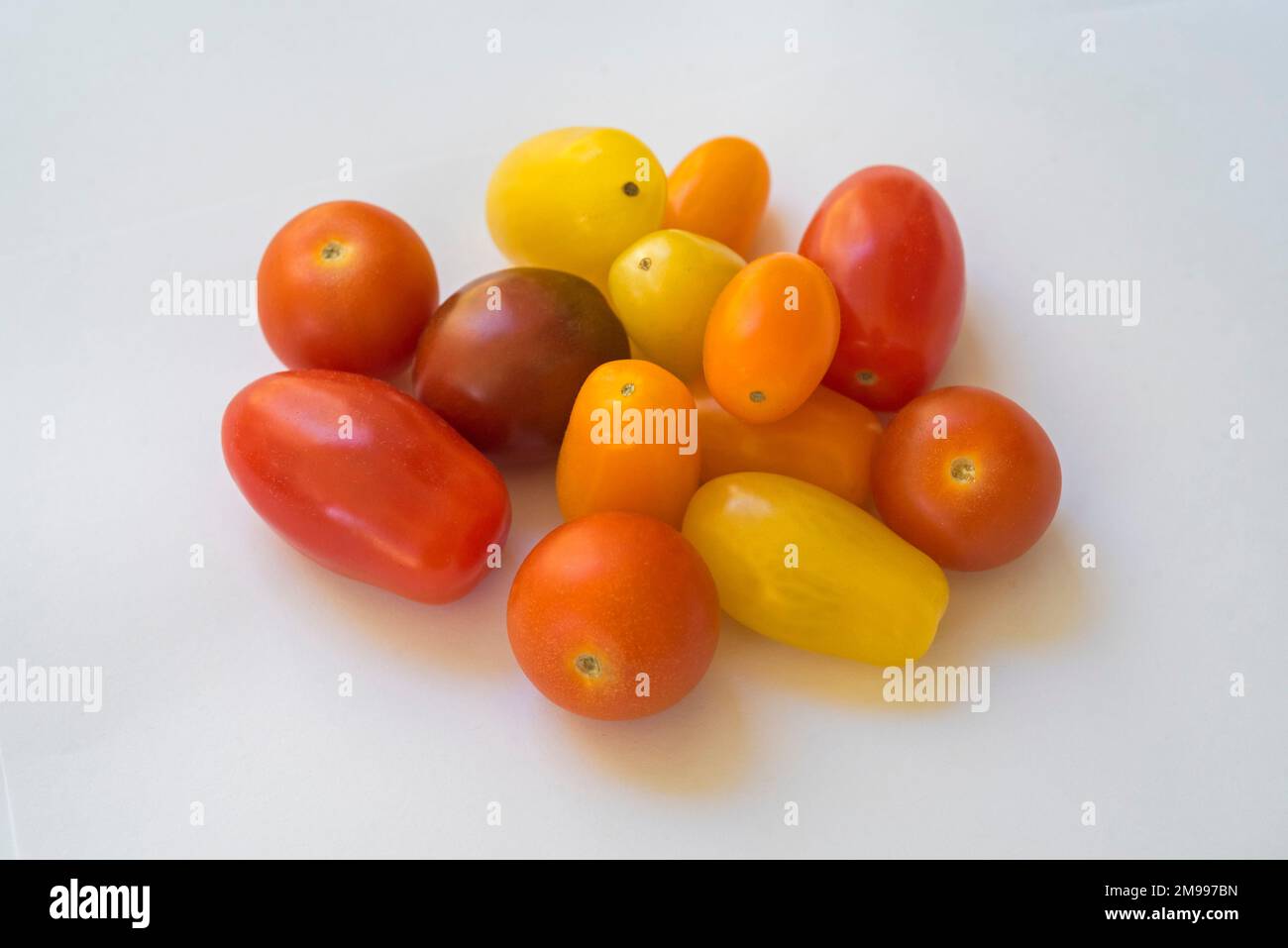 Small Rainbow-colored cherry tomatoes. Stock Photo