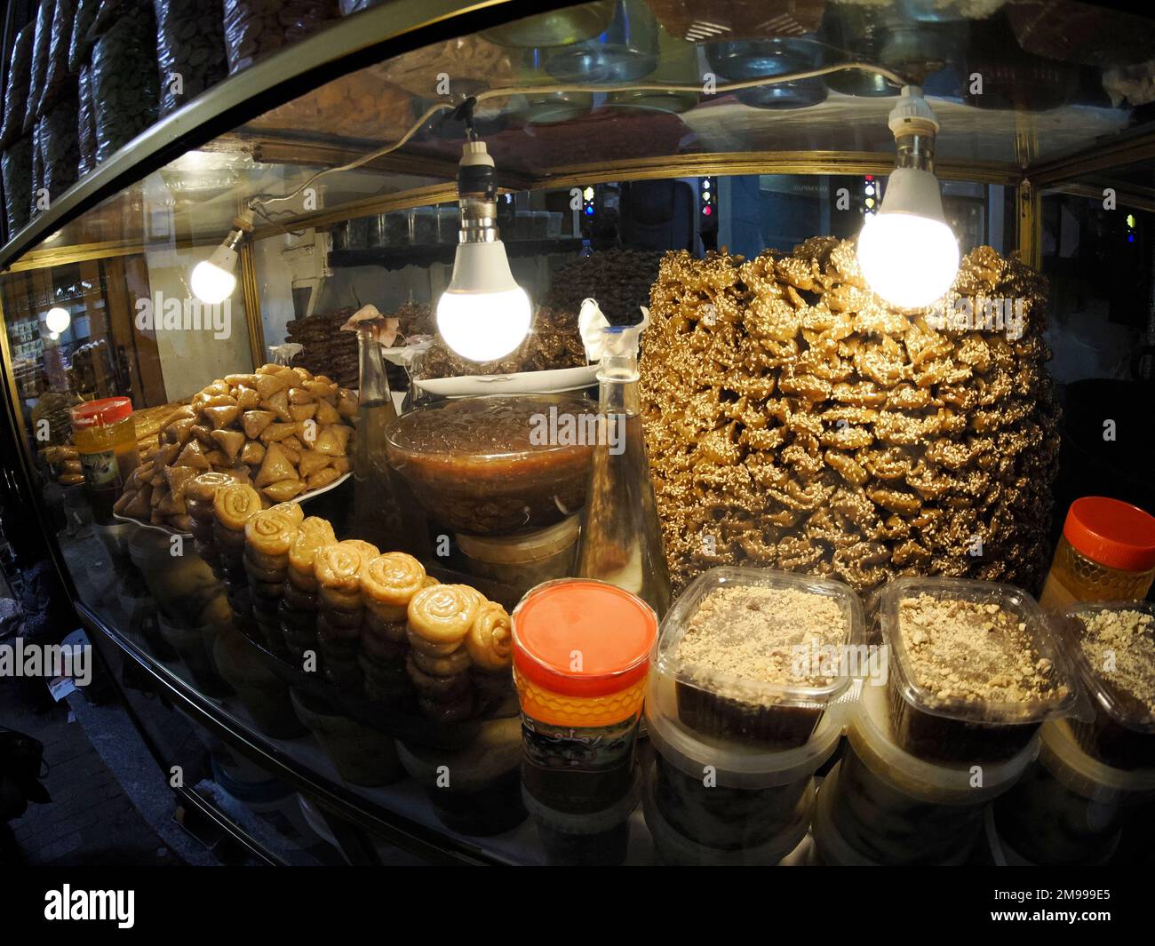 Moroccan biscuits and pastries dipped in honey for sale in the Medina