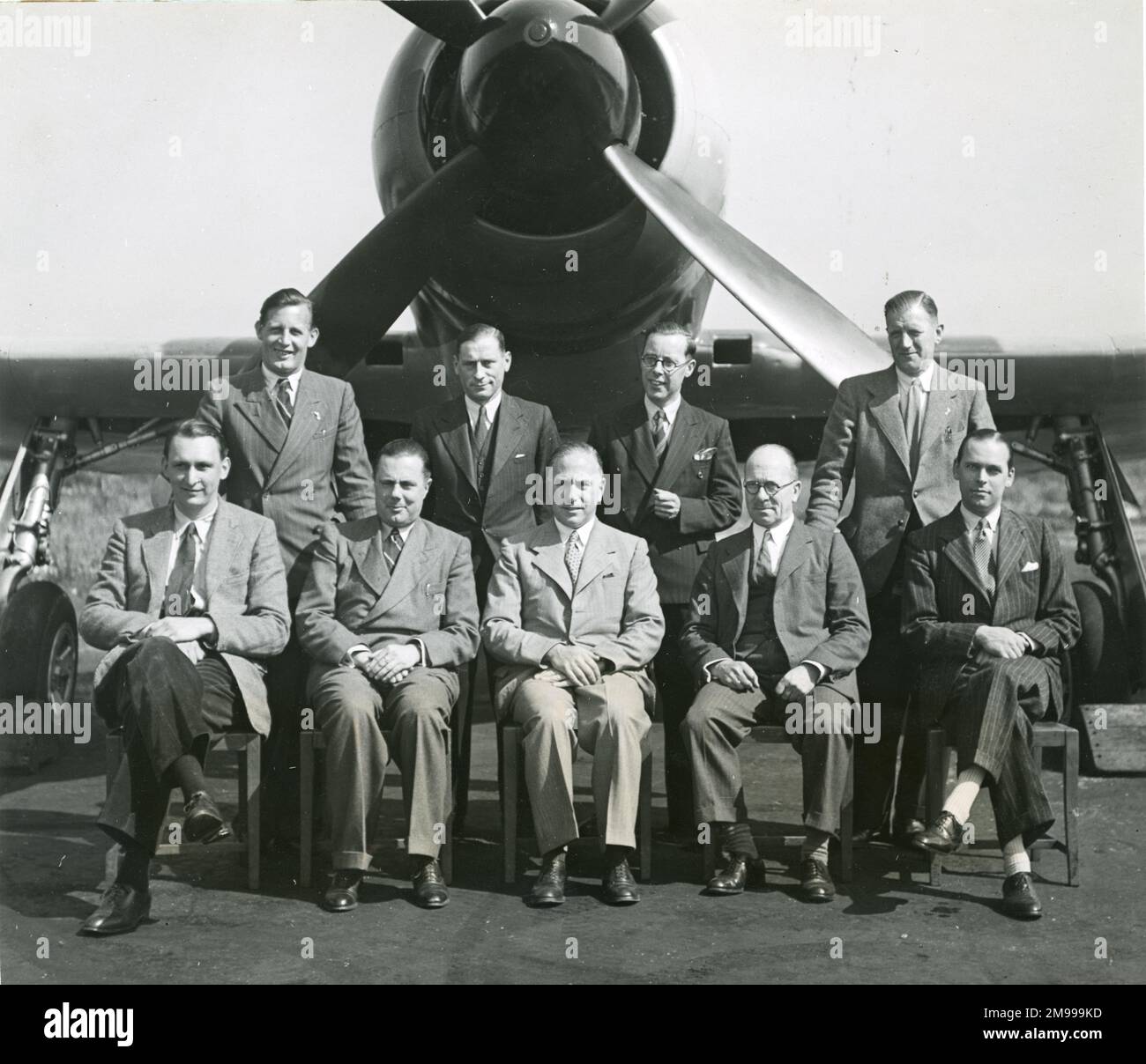 The Napier experimental team in front of Hawker Tempest V, NV768, fitted with an annular radiator, July 1946. Standing: F.S. Lester, Flight Test Engineer; R.C. Marcell, Chief Draughtsman; K.H. Greenly, Project Engineer and S.A. Clark, Chief Inspector. Seated: Mike Randrup, Chief Test Pilot; F.L. Parris, Works Manager; C.L. Cowdrey, Chief Installation Engineer; C.F. Vickers, Chief Designer and J.B. Waite, Liaison Engineer. Stock Photo