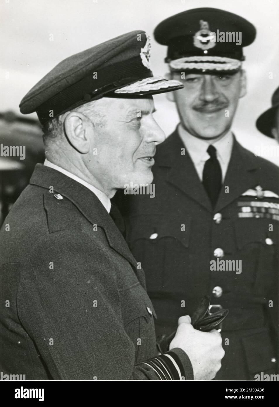 Chief of the Air Staff designate Royal Air Force, Air Chief Marshal Sir William Dickson and Chief of the Air Staff Royal Australian Air Force, Air Marshal Sir Donald Hardman, chat together on the tarmac at RAAF Laverton shortly after Sir William landed in a RAF Hastings. Stock Photo