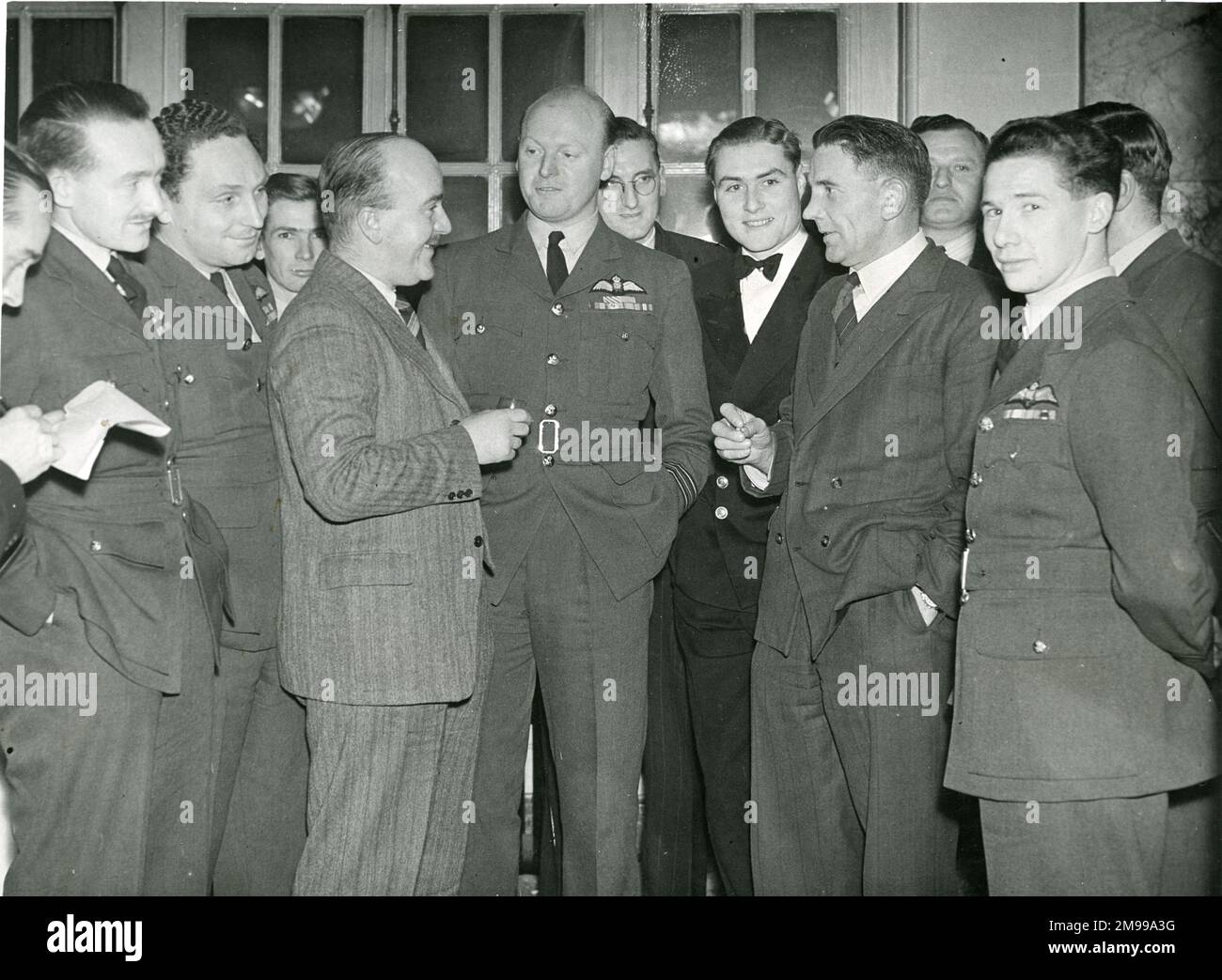 Students from No 6 Course Empire Test Pilots?s School toured the Avro factories on 15 and 16 December 1947 when they completed a series of visits to the aircraft manufacturers. Enjoying a cocktail before dinner are, from left: Sqn Ldr R.A. Watts, Flt Lt D.A. Dunlop, DSC, DFC; A.K. Cooke, Avro Test Pilot; Sqn Ldr K.J. Sewell, AFC, DFM, Tutor-Flying ETPS; Lt R.H. Reynolds, DSC, J.M. Orrell, Avro Chief Test Pilot; and Flt Lt G.S. Chandler. Stock Photo