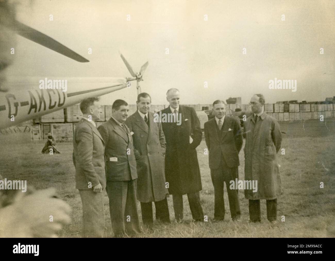 From left: GPO(?), Mayor of Peterborough(?); Gerard d?Erlanger, Chairman and Chief Executive, BEA; Word, Chief Executive, BSAA; Wg Cdr R.A.C. ?Reggie? Brie ; and N.E. Rowe, alongside Sikorsky S-51, G-AKCU, of BEA, at Peterborough, prior to the first helicopter-operated public mail service in the UK on 1 June 1948. Stock Photo