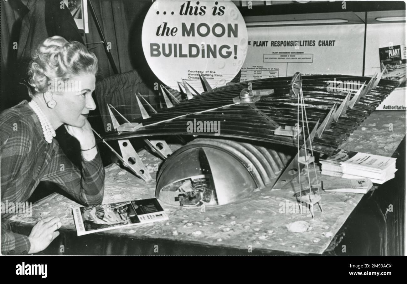 Jean Zeller, a visitor to the Plant Maintenance and Engineering Show in Philadelphia?s Convention Hall, studies a model of a proposed Moon base, circa 1960. Stock Photo