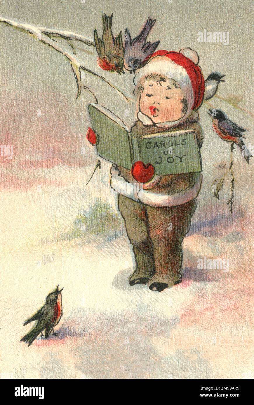 Little boy (and birds) singing Christmas carols in the snow Stock Photo