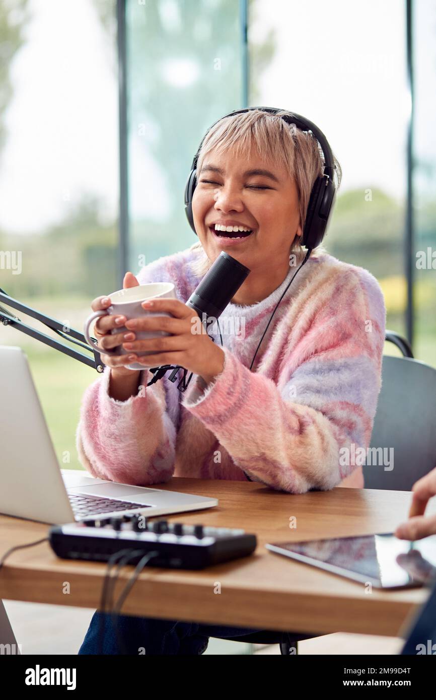 Woman Recording Podcast Or Broadcasting On Radio In Studio At Home