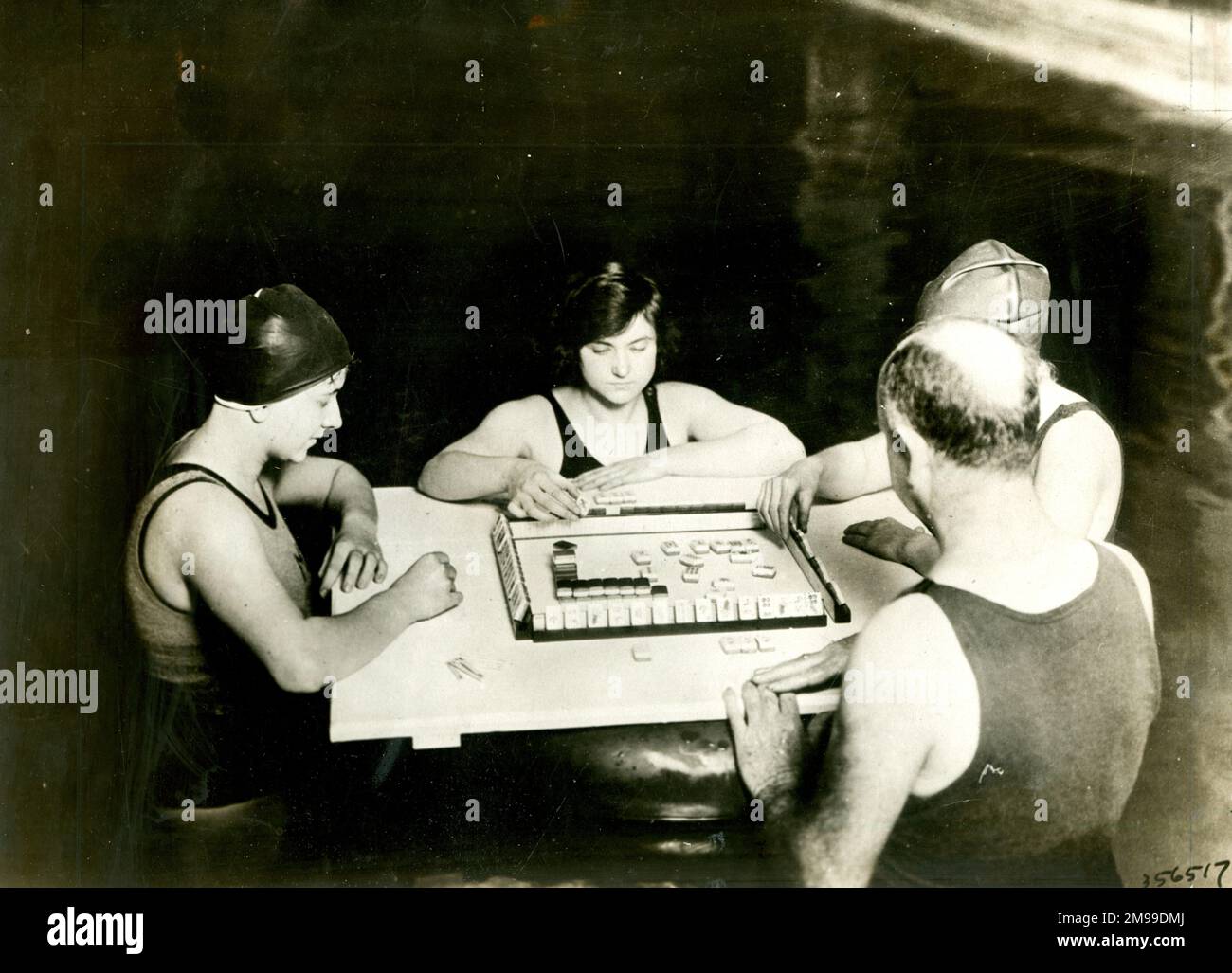 People playing the Chinese board game Mahjong (Mah Jong), by the swimming pool of the Ambassador Hotel, Atlantic City, USA, April 1924. Stock Photo