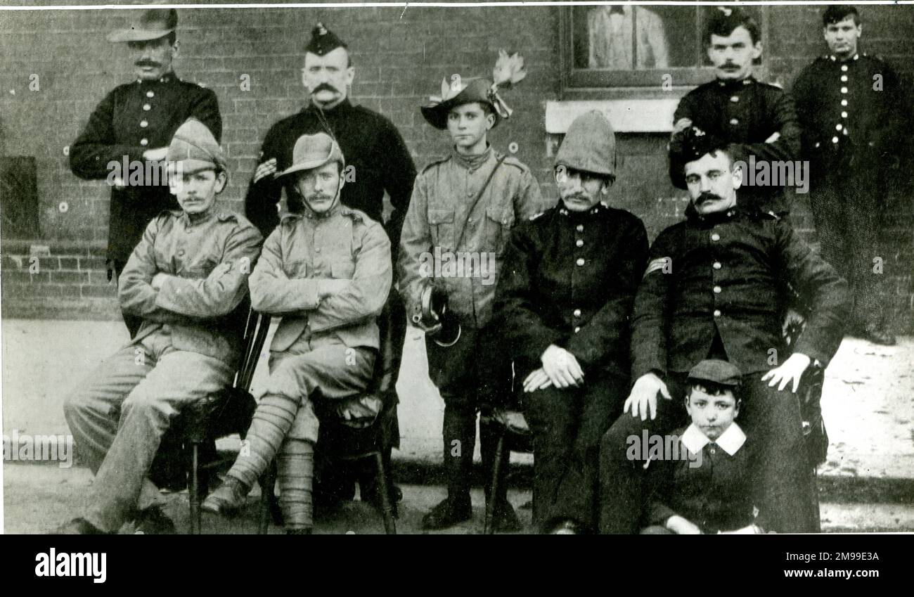 Group photo of Boer War soldiers, including Bugler John Francis Dunne (the boy seated on the ground, right), who saw action at the Battle of Colenso (December 1899) with the Royal Dublin Fusiliers. He was invalided home in 1902 and received the Queen's South Africa Medal for bravery. Stock Photo