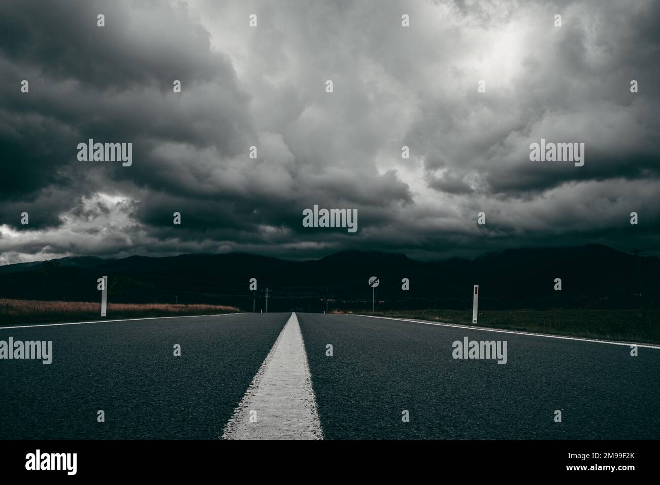An empty asphalt road on a stormy day Stock Photo - Alamy