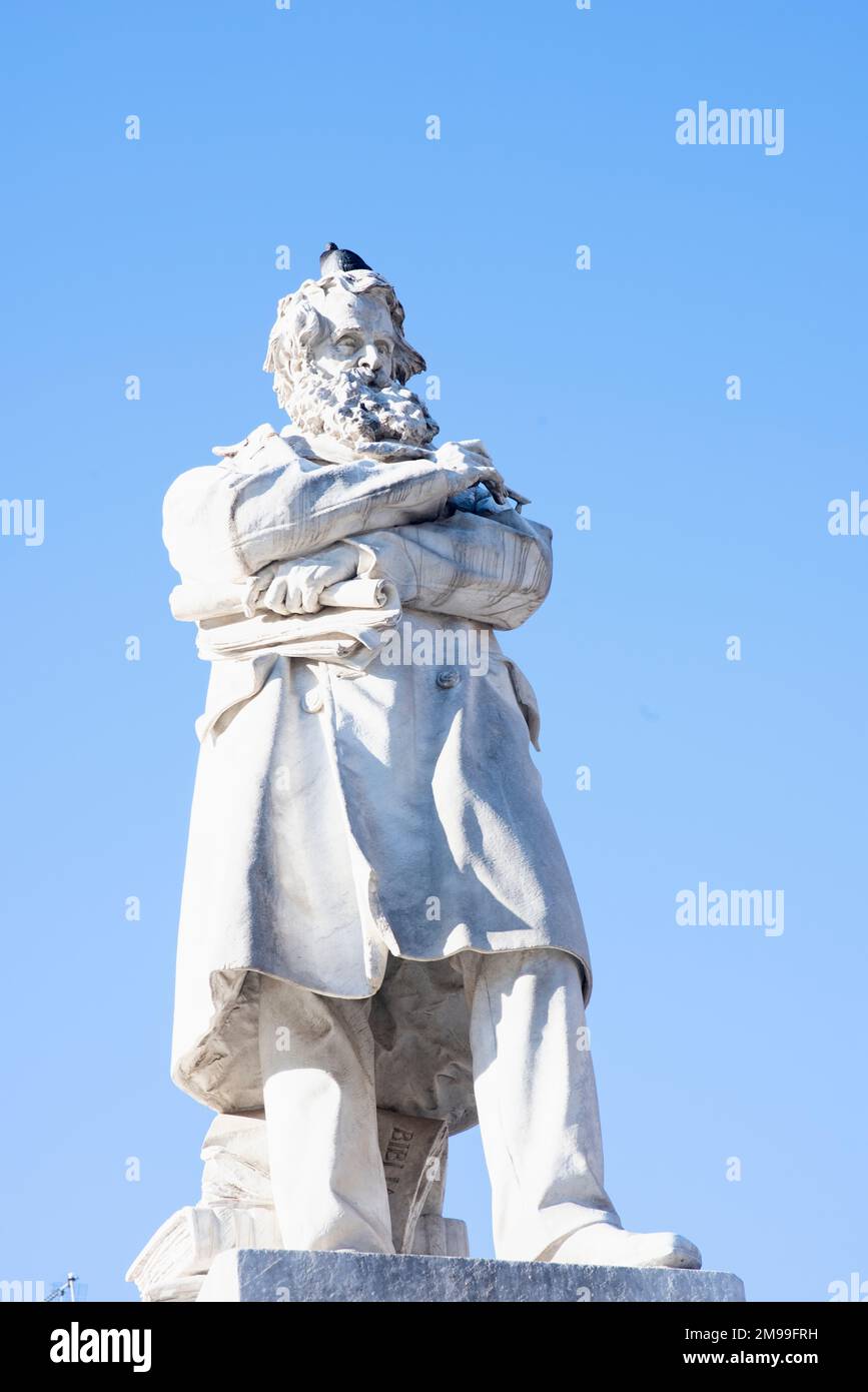 The statue of Niccolo Tommaseo famous literary writer against the blue sky in Venice, Italy Stock Photo