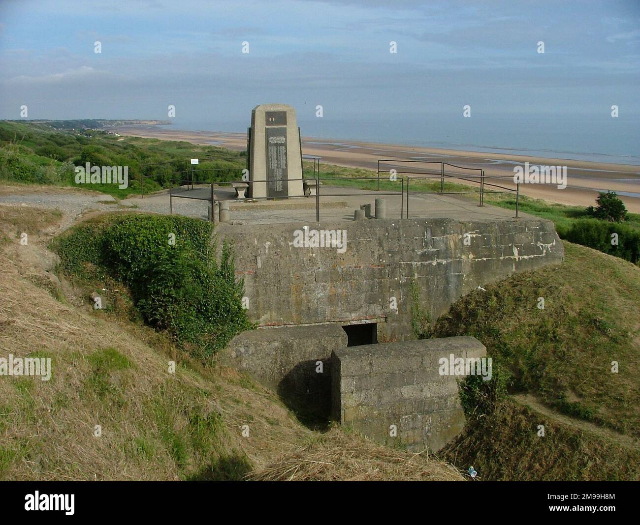 The memorial is standing on German bunker WN62 and  overlooks Omaha Beach. It has a number of memorial plaques one or more of which has been stolen. They  included 20th & 299th Engineers, 146th Engineer Combat Battalion & 6th Naval Beach Battalion. The Engineers were awarded the Croix de Guerre whose emblem is shown. Stock Photo
