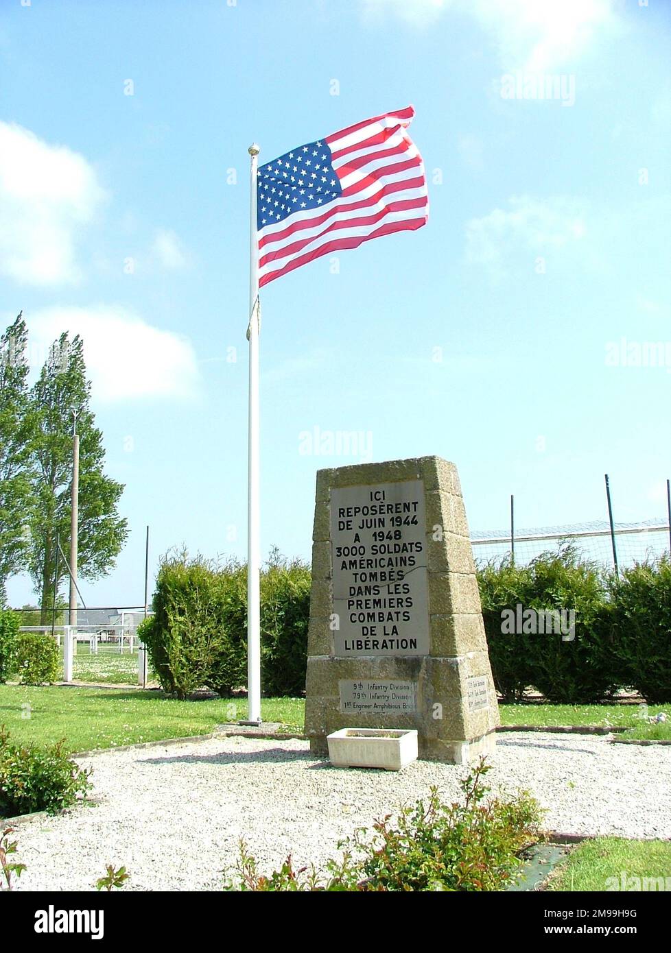 This is one of three markers at the locations of the first American cemeteries. There were 3,000 soldiers buried  here. By 10 June there were eight battlefield cemeteries  but these were later concentrated into five - St Laurent  (Omaha), Blosville, La Cambe, Orglandes and here. Stock Photo