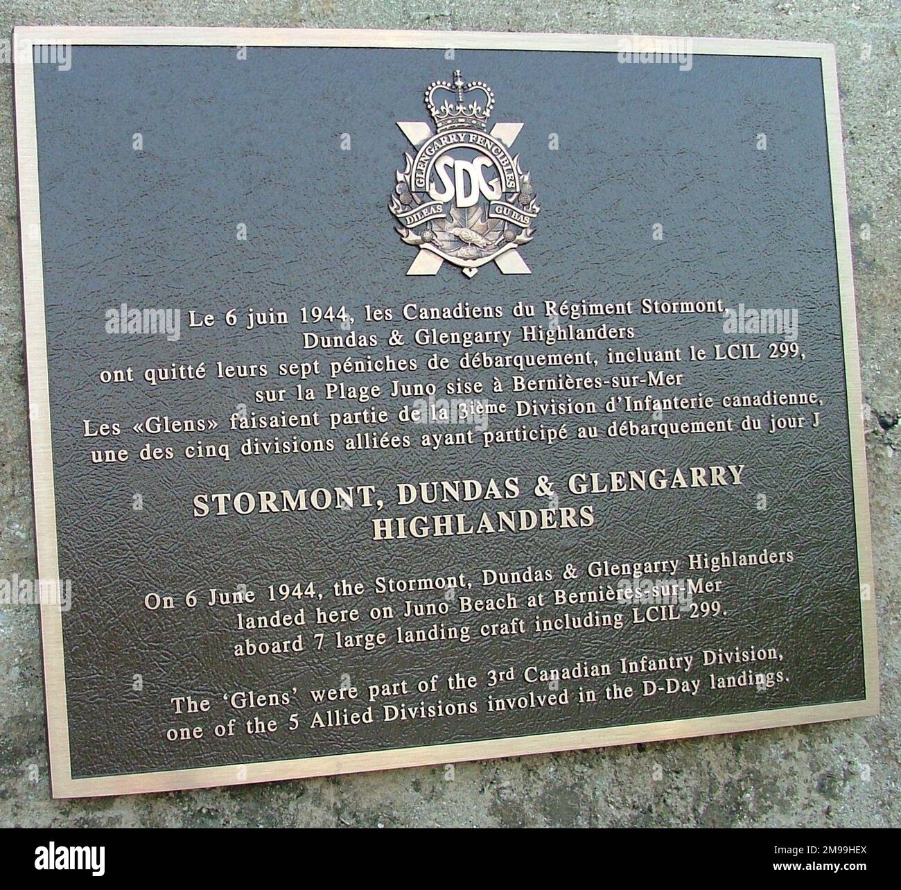 This is one of the plaques on a German bunker on the edge of Juno Beach at Bernieres. The Highlanders came ashore on D Day and were one of the first (if not the first, but there are other claimants) formations into Caen on  9 July. Stock Photo