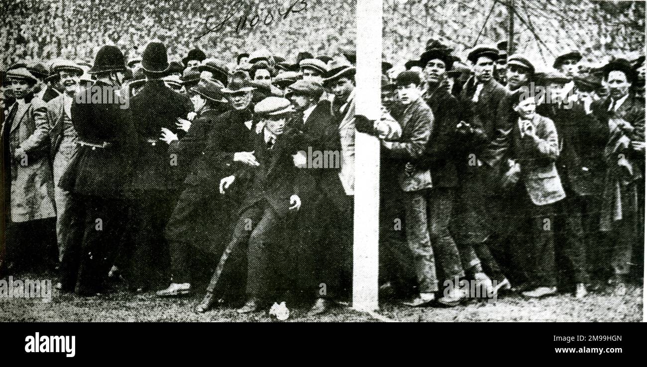 The crowd being held back at the FA Cup Final between West Ham United and Bolton Wanderers at Wembley, 28 April 1923. There were so many spectators that they were spilling over onto the pitch, causing the start of the match to be delayed by 45 minutes. Stock Photo