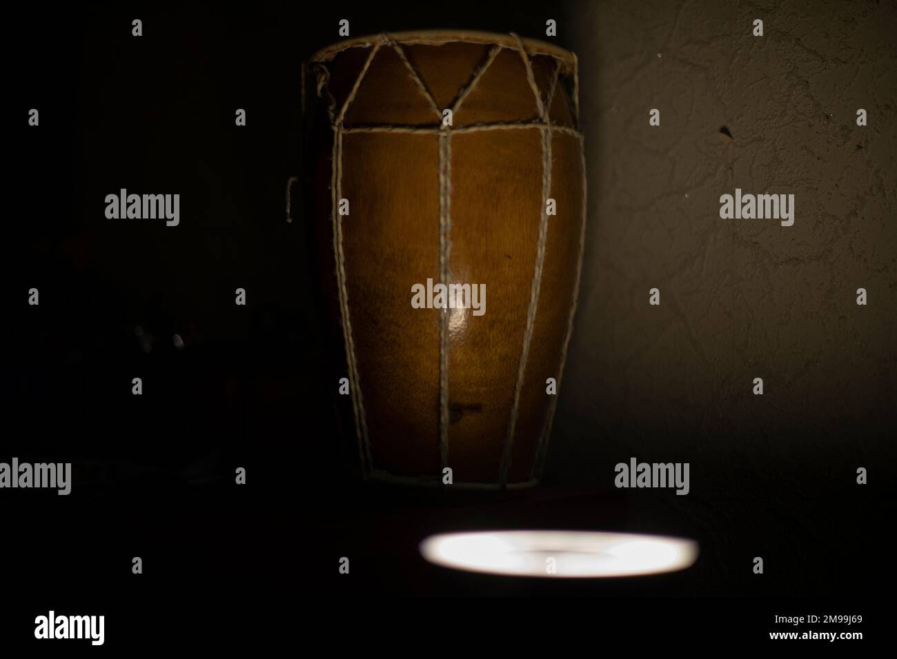 African drum. Acoustic instrument. Shock intrusion at home. Brown tree. Ropes and leather. Stock Photo