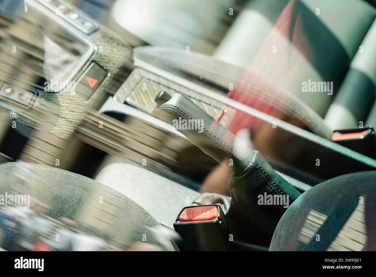 Manual brake in interior of modern car, with reflections in the window. Stock Photo