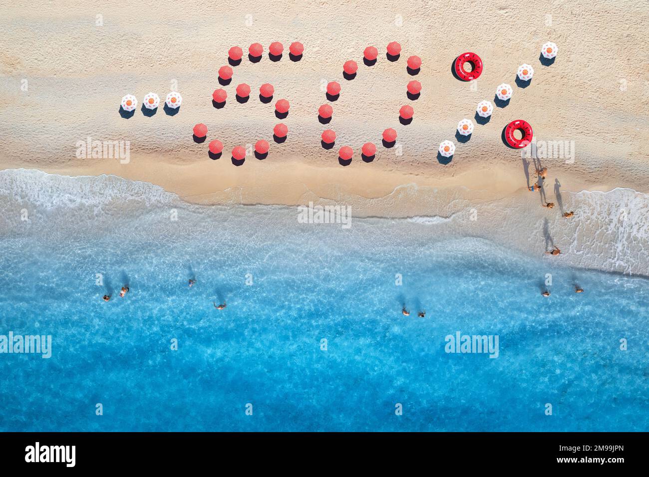 Creative text - 50 percent made from umbrellas on sandy beach Stock Photo