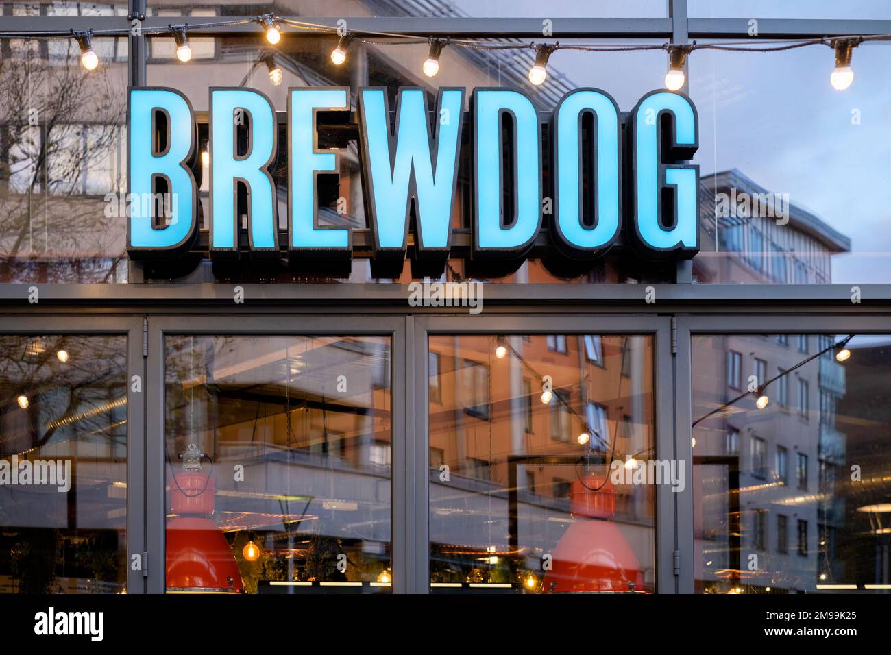 A large Brewdog pub situated on the harbourside at Bristol, UK. The illuminated Brewdog logo is clearly shown on a large sign at the front of the pub Stock Photo