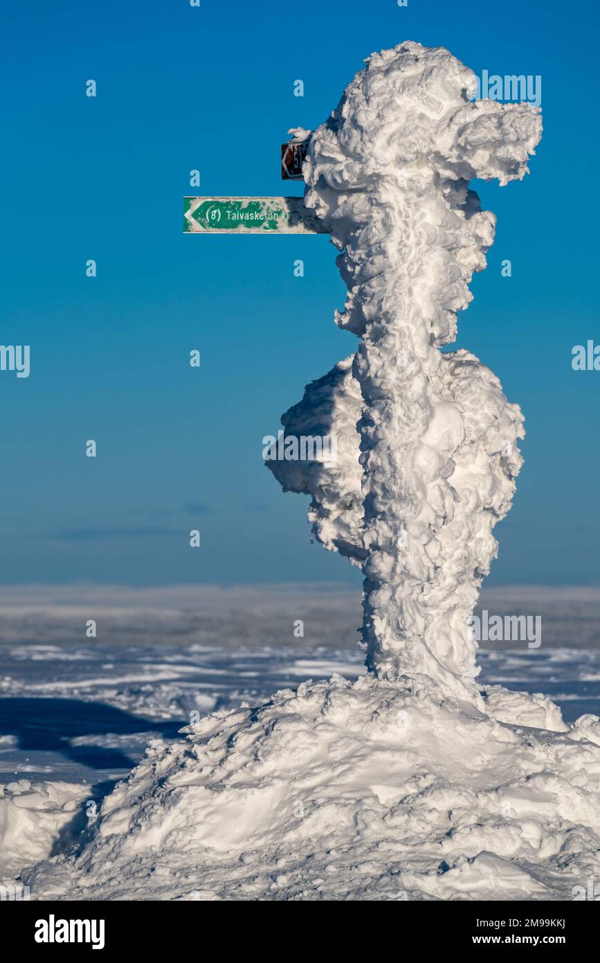 A very snow covered direction indicator at Pallastunturi fell, Muonio, Lapland, Finland Stock Photo