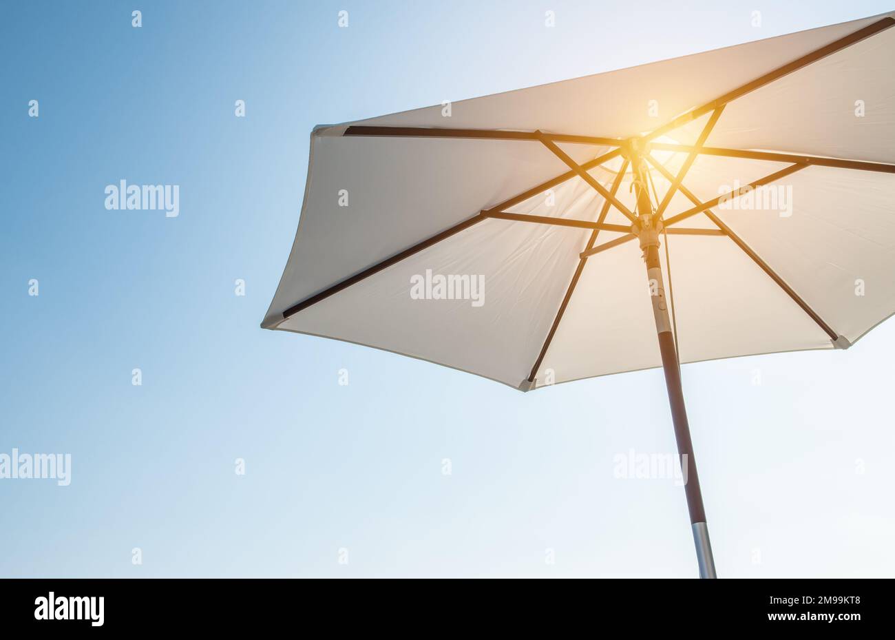 Hot summer relaxation and vacation concept with luxury umbrella. Stock Photo