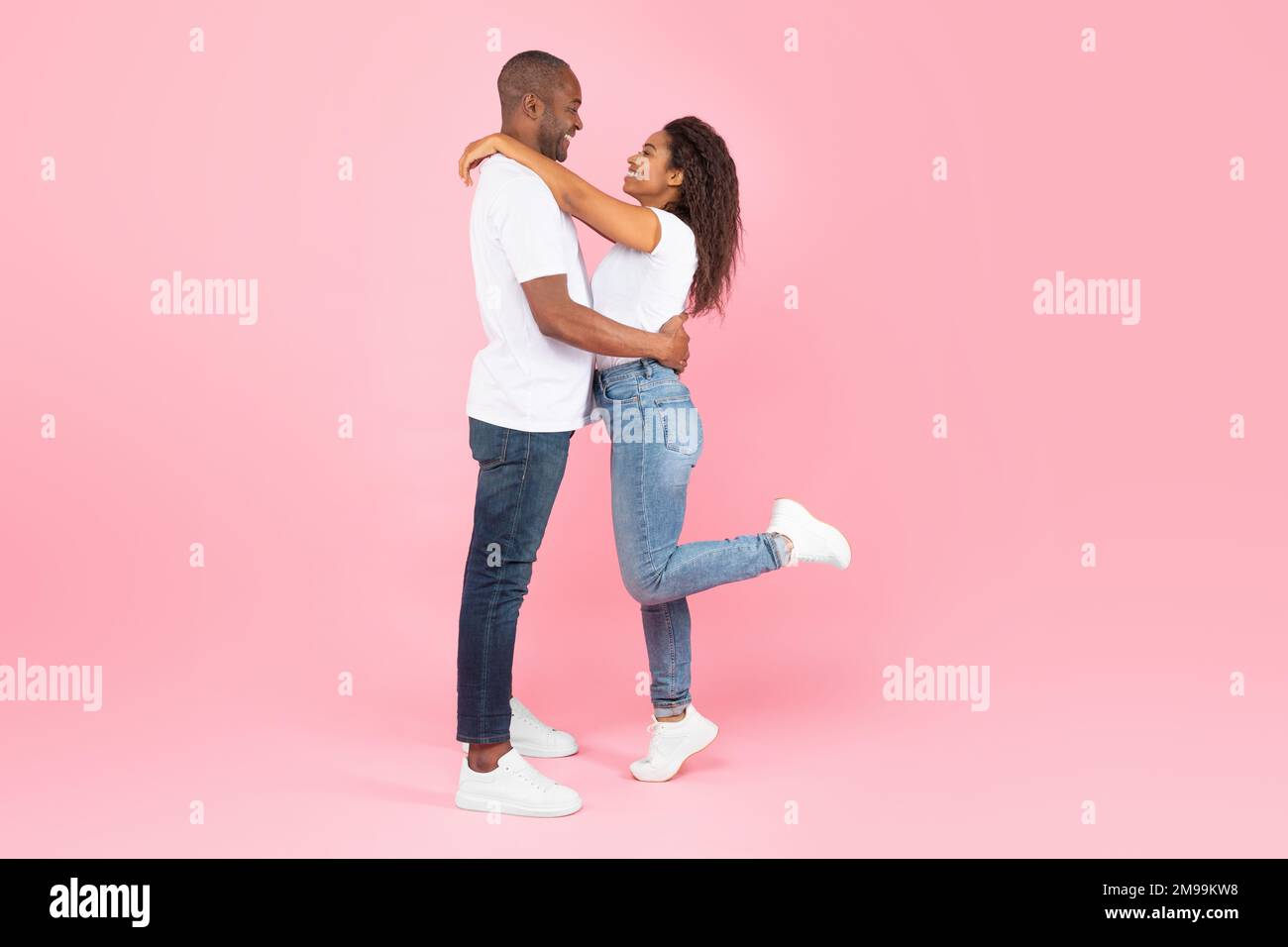Side view of loving african american couple hugging and looking at each ...