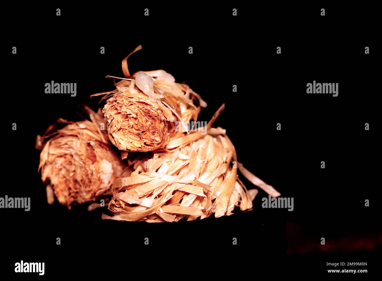 pile of firestarter also known as firewool or kindling isolated against black background Stock Photo