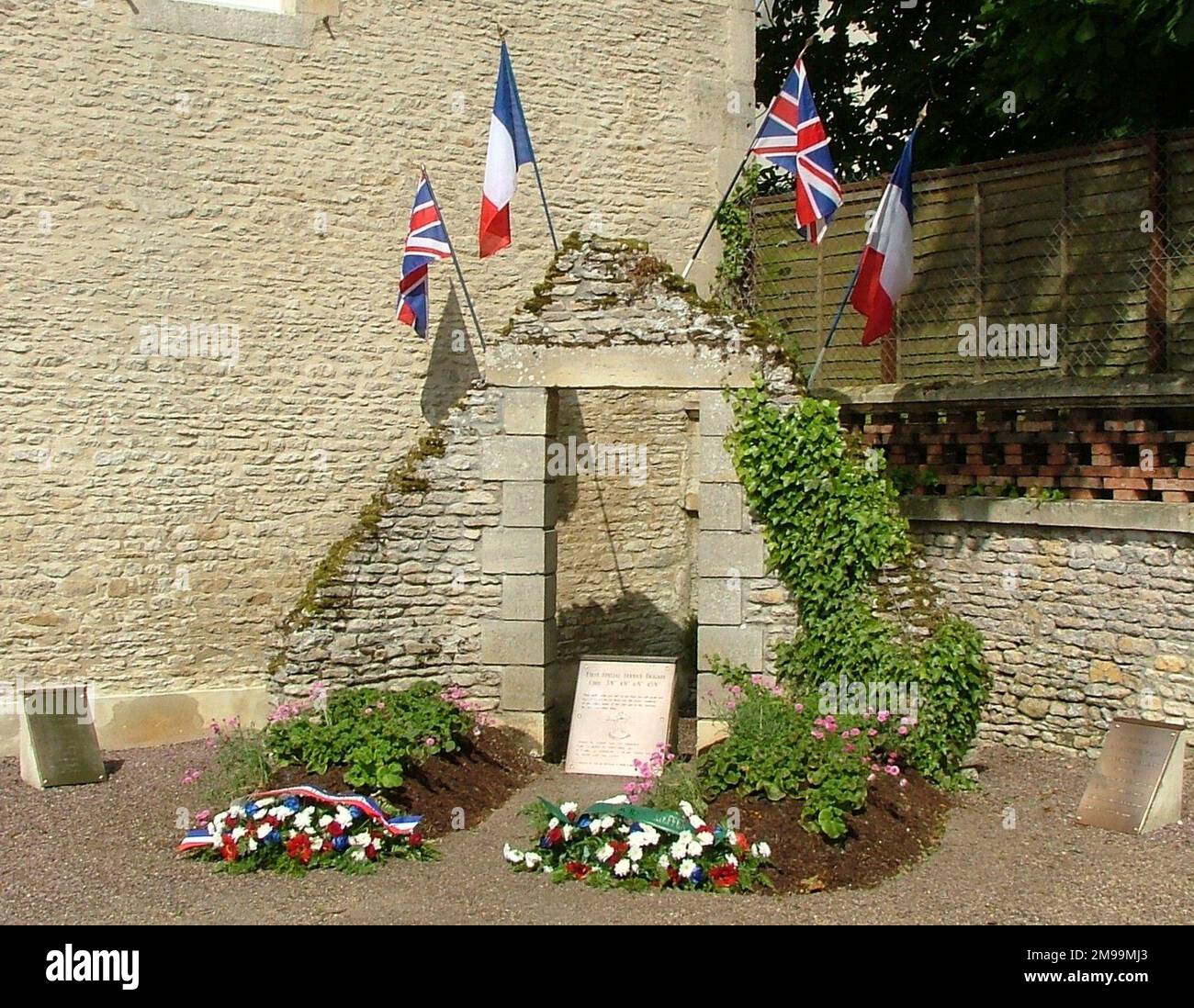 In the centre of this rather untidy collection of memorials in the centre of the village is one to 1st Special Service Brigade and flanking it are plaques to the Civilian Victims and to 6th Airlanding Brigade in Operation Mallard. This was the code name for the second lift of airborne troops into Normandy. The leading aircraft began to arrive around 2100 hours on D-Day. Stock Photo
