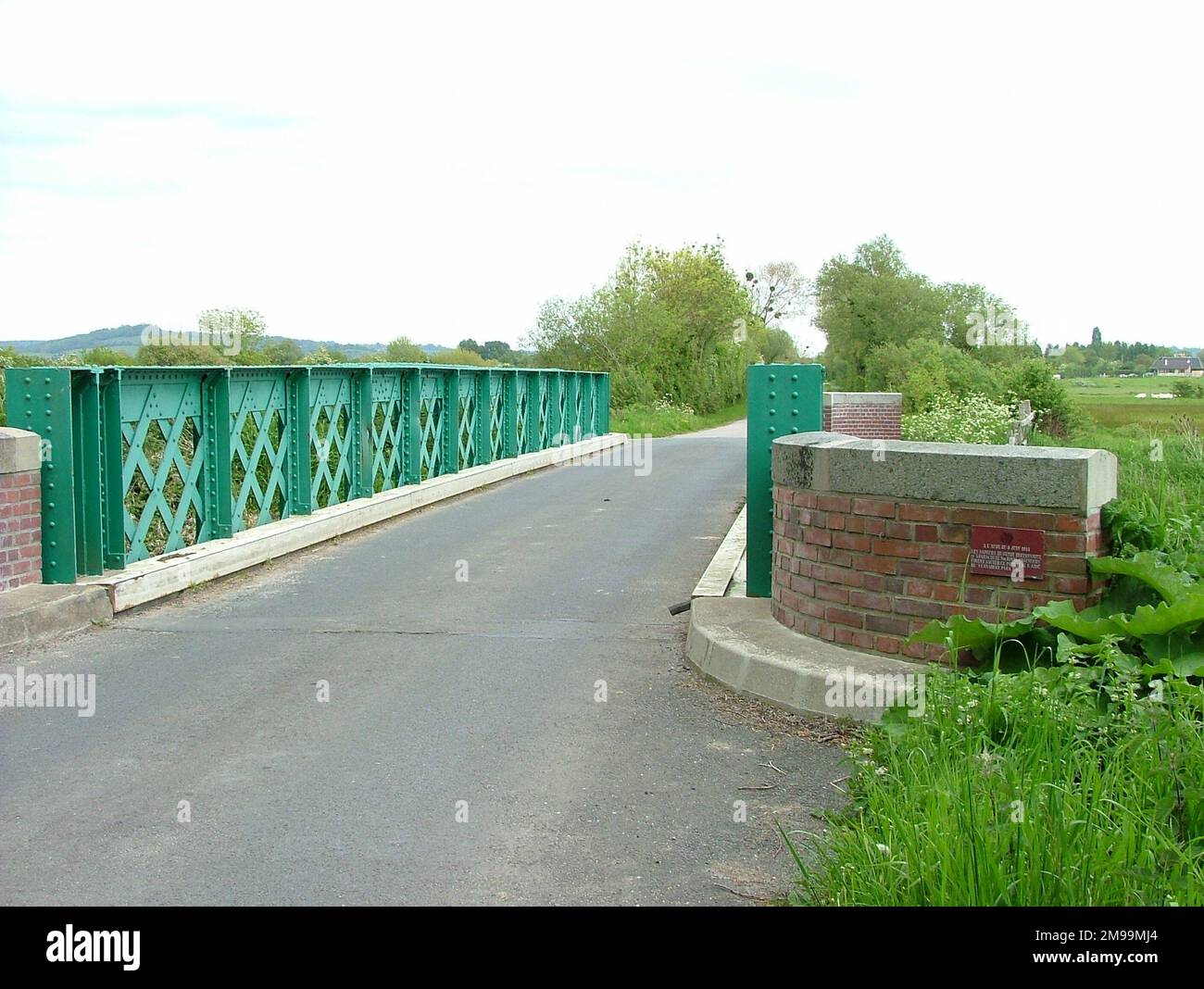 This is one of the few remaining, perhaps the only one, of the bridges built by the Engineers to replace original structures over the River Dives that were destroyed at dawn on D-Day. Just visible in the centre of the right hand end of the brick wall is a small plaque that commemorates the 1st Canadian Parachute Battalion and the 3rd Parachute Squadron. Stock Photo